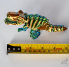 skeleton t rex figure next to measuring tape for scale