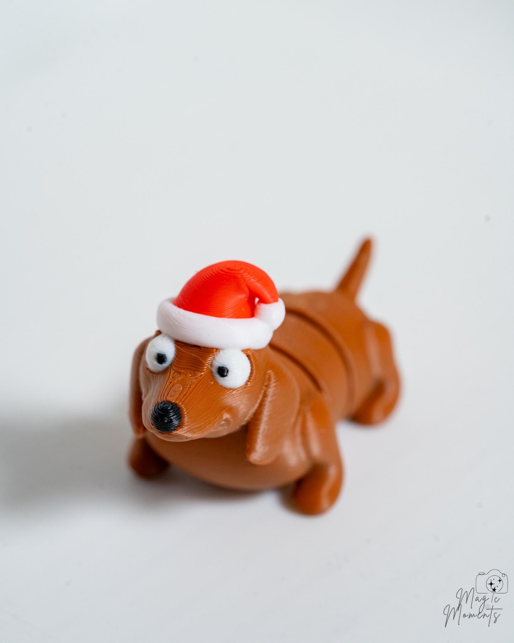 dachshund wearing a Santa hat on a white background