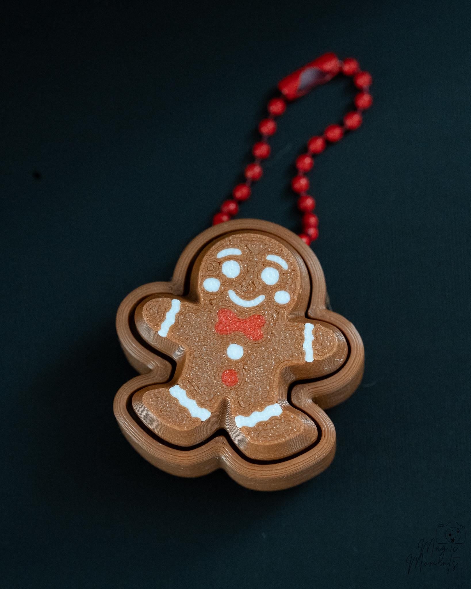 Gingerbread man clicker with red hanging loop and cookie style design