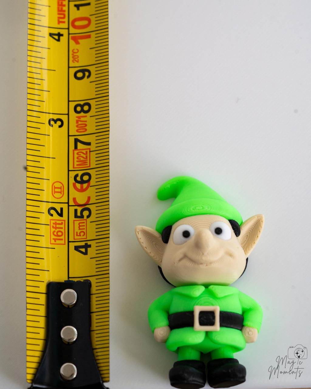 christmas elf next to measuring tape for scale