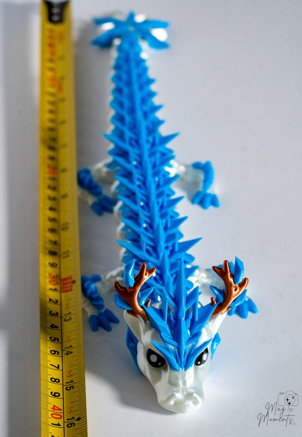 Ice dragon figure next to measuring tape for scale
