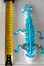 Ice dragon figure next to measuring tape for scale