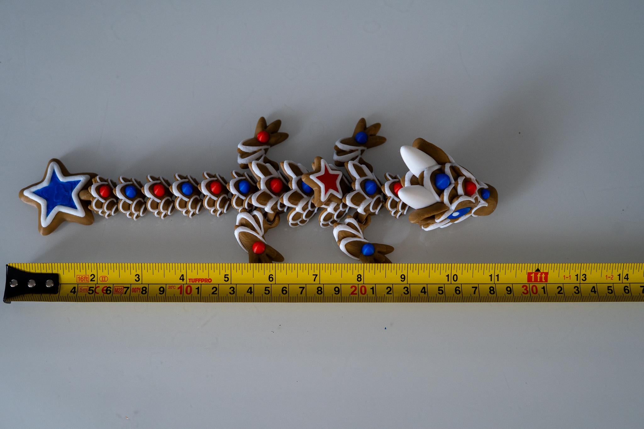 gingerbread dragon next to measuring tape for scale