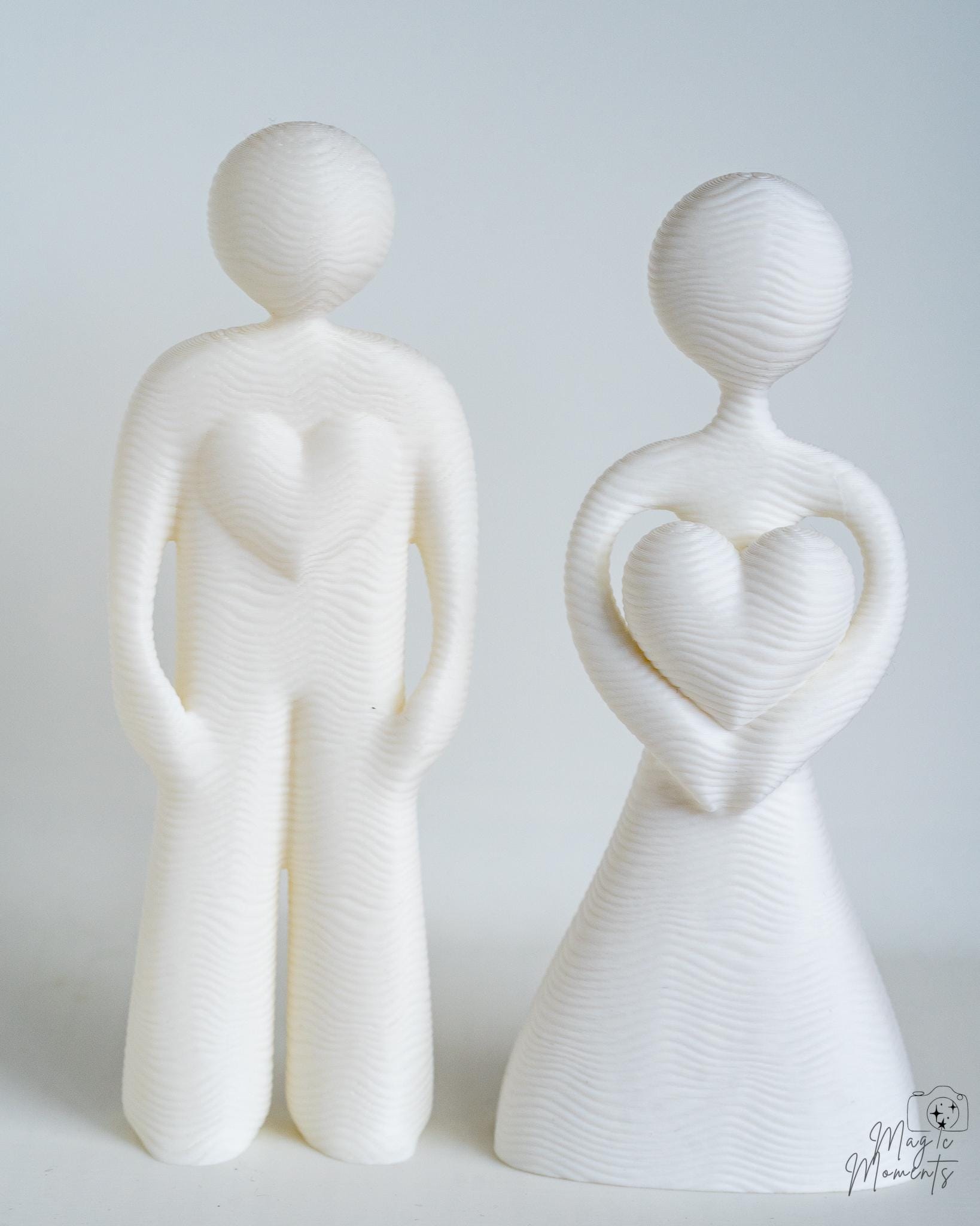 Minimalist couple sculpture with heart shaped centre detail