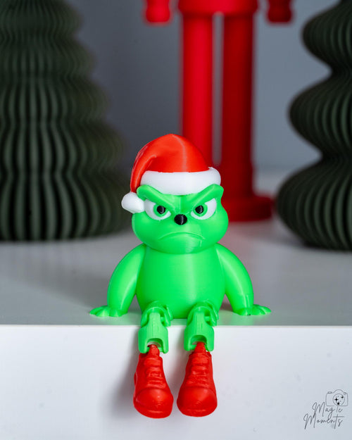 Green grumpy Christmas character shelf sitter with Santa hat and dangling legs